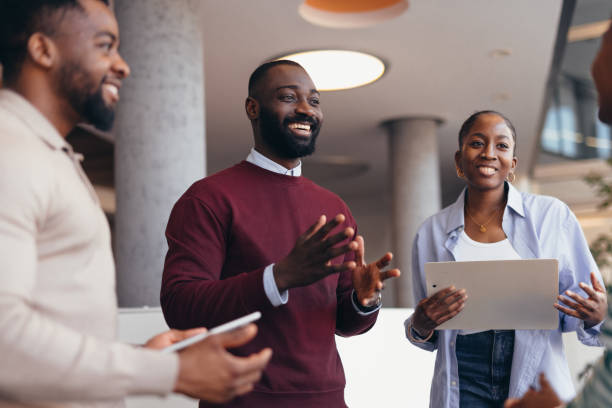 Group of young african entrepreneurs discussing a project in a modern office