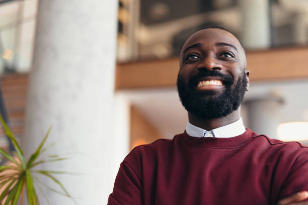 istock Young businessman smiling and looking up in modern office 2198395138