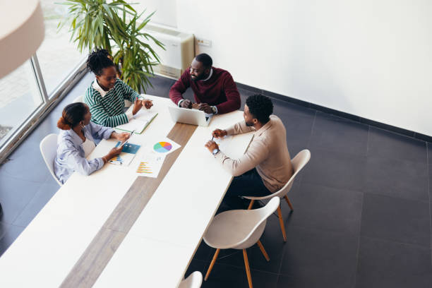 istock Four Young Professionals Collaborating on a Project in a Modern Office 2198395334