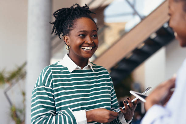 istock Young businesswomen smiling and discussing work in the office 2198396112