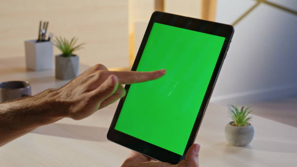 istock Employee working chromakey tablet at cozy workplace closeup. Businessman hands 2198400172