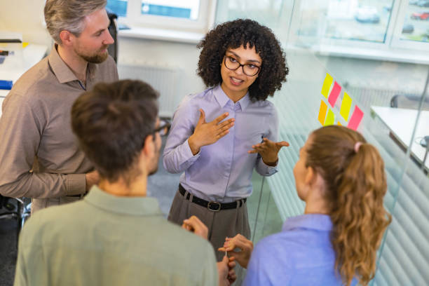 istock Creative group or business people planning innovation with sticky notes on glass wall. Top view 2198400422