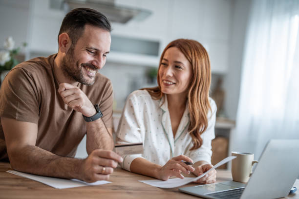 istock Couple enjoying online shopping session at the table 2198400813