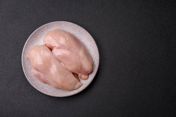 istock Raw chicken or turkey fillet with salt, spices and herbs 2198403253