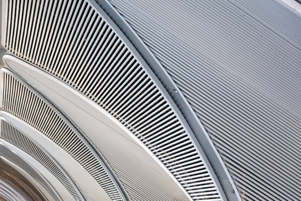 Modern white ceiling with longitudinal stripes on it and holes in between.