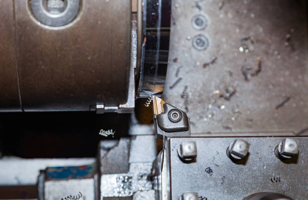 Turning a steel billet on a lathe with a cutter.