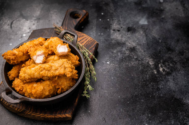 istock Fried chicken fillet tender strips. wooden background. top view 2198404679