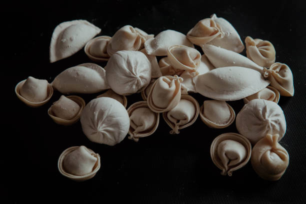 istock Semi-finished dumplings on a black background 2198404910