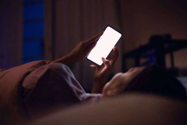 Person Using Smartphone in Bed at Night for Evening Browsing