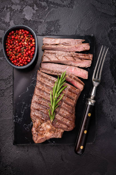 istock Grilled medium beef Rump steak on marble board. black background. top view 2198405689