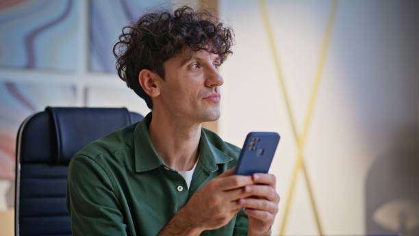 istock Entrepreneur browsing banking app at cellphone feeling satisfied office closeup. 2198406980