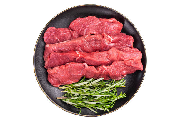istock Raw bison meat presented with fresh herbs and spices, inspiring bold flavors and unique recipes for adventurous food lovers. isolated on white background. top view 2198407230