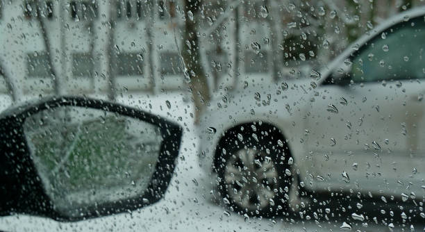 istock View from inside a car onto an open air parking lot on a winter day through drops pattern on the glass 2198412301