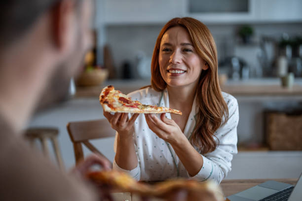 istock Happy couple savoring pizza together 2198412510