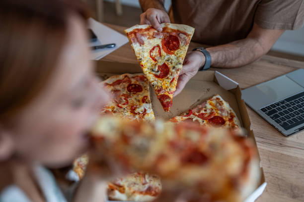 istock Pizza lovers - Couple sharing a tasty meal 2198412605