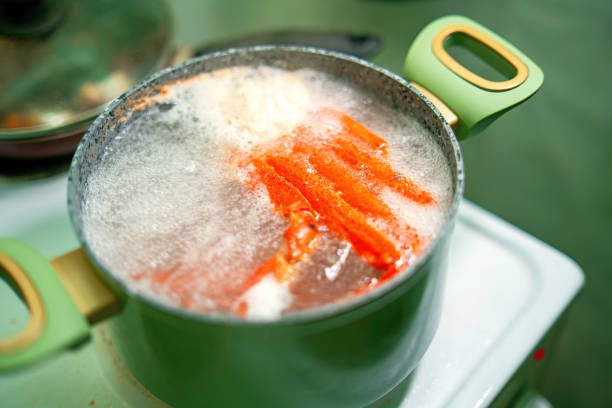 istock crab claws submerged boiling water inside green pot, showcasing cooking process of fresh seafood. Ideal for culinary, food preparation, and seafood-themed content 2198412654
