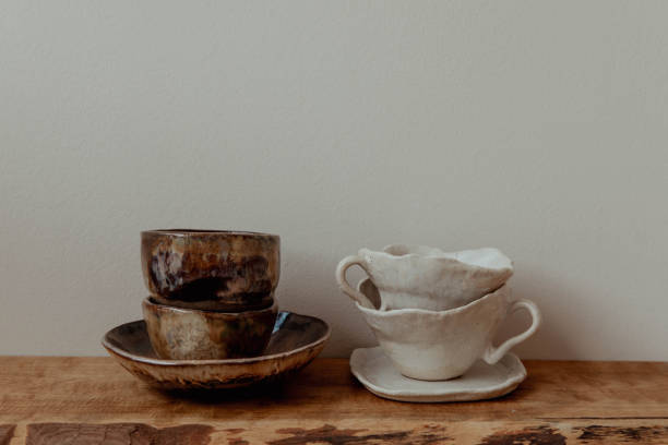 istock Handmade ceramic cups on a wooden shelf 2198415549