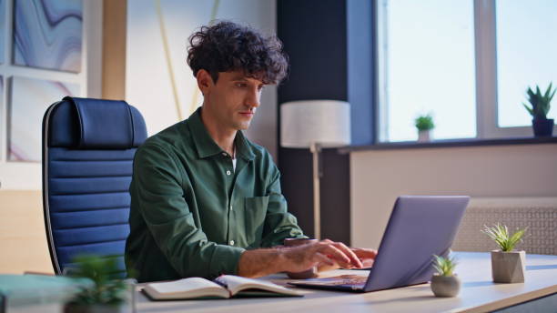 istock Startuper working business plan sitting office workplace with laptop closeup. 2198418963