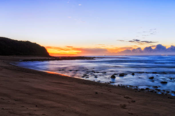 Scenic Pacific ocean sunrise at Hams beach in Caves beach town of Australia - seascape.