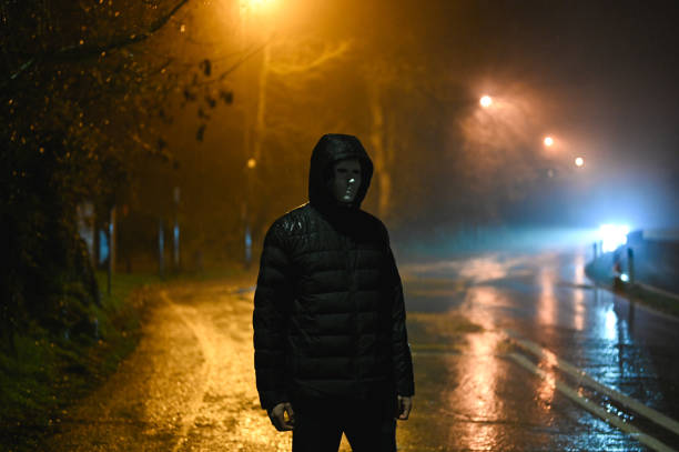 istock Man in mask on night street. 2198423783