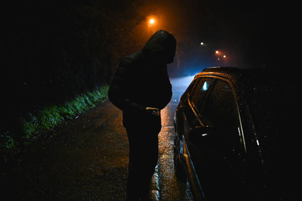 istock Car thief at night parking. 2198423858