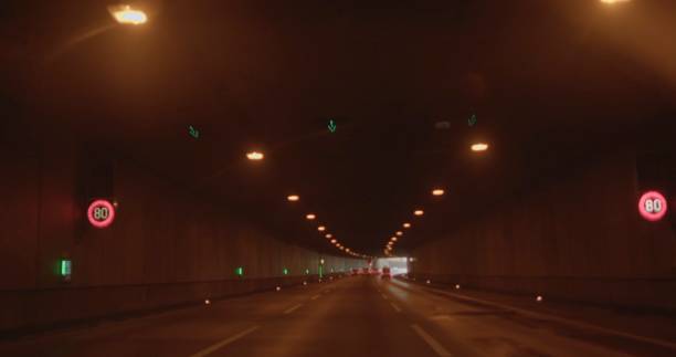 istock A vast, empty tunnel featuring distinct traffic lights and clear road markings 2198429724