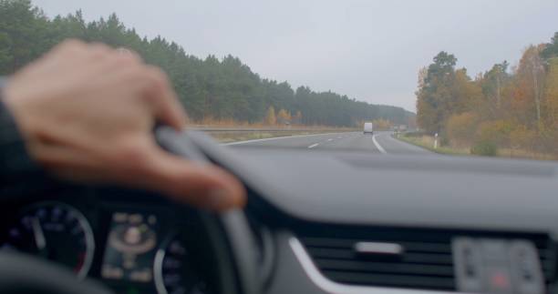 istock Driving on a beautiful country road with a scenic forest backdrop 2198431563