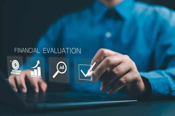 istock Financial evaluation concept. Businessman using laptop financial evaluation icon on virtual screen for analysis business financial report. 2198432397