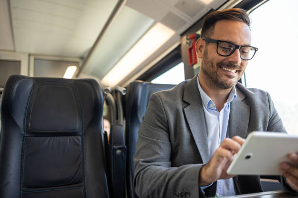 istock Businessman on the go, working on a tablet in a train 2198432640
