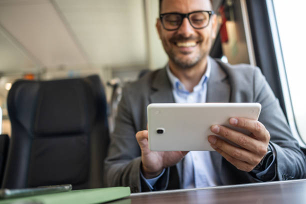 istock Businessman on the go, working on a tablet in a train 2198432645