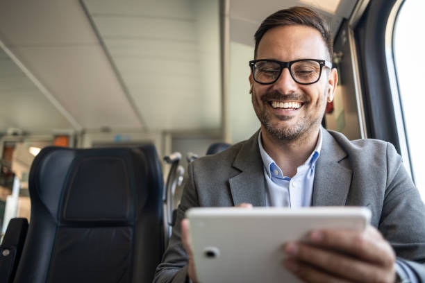 istock Businessman on the go, working on a tablet in a train 2198432646