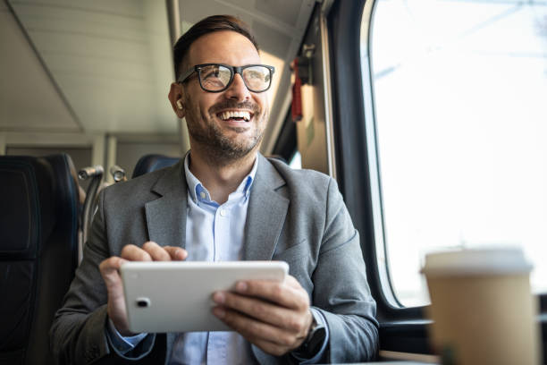 istock Businessman on the go, working on a tablet in a train 2198432647