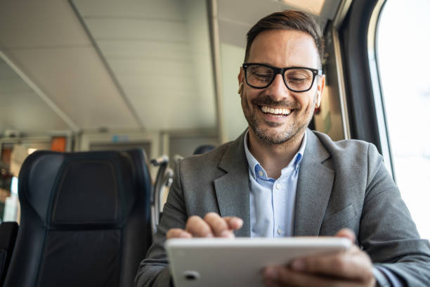istock Businessman on the go, working on a tablet in a train 2198432658