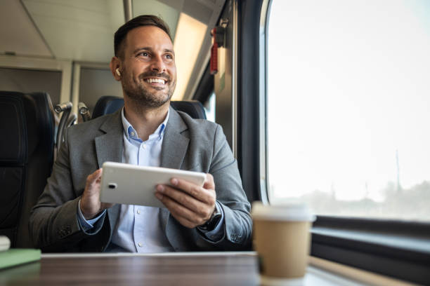istock Young businessman managing work on his tablet while traveling 2198432665
