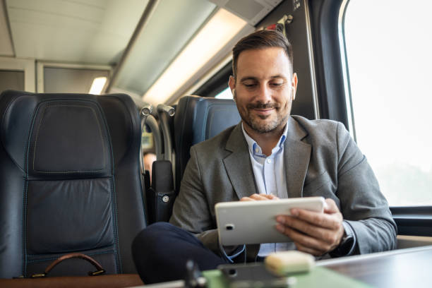 istock Young businessman managing work on his tablet while traveling 2198432670