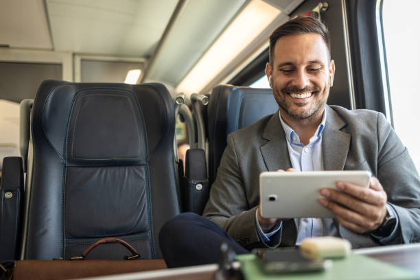 istock Young businessman managing work on his tablet while traveling 2198432671