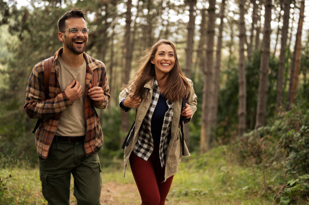 istock Happy young couple hiking through nature 2198435494