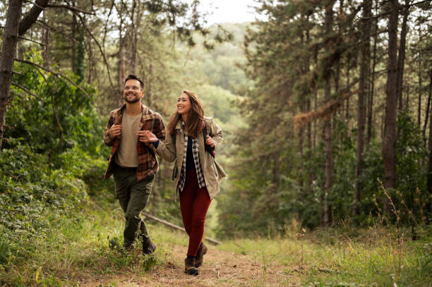 istock Happy young couple hiking through nature 2198435552