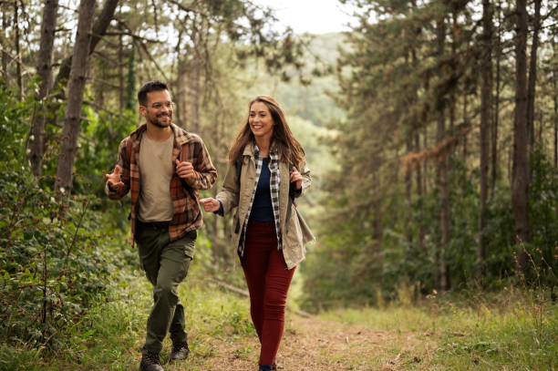 istock Happy young couple hiking through nature 2198435554