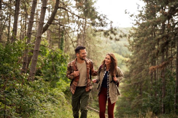 Happy young couple hiking through nature
