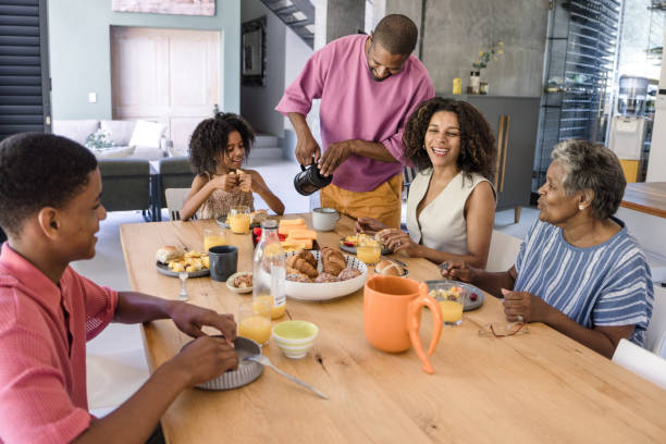 istock A mother and father serving breakfast to their two kid 2198439742