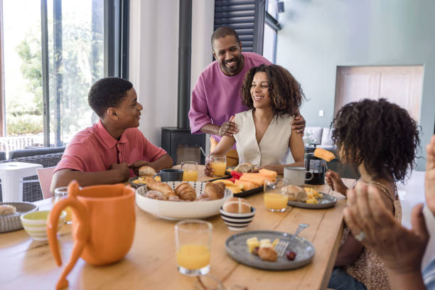 istock A mother and father serving breakfast to their two kid 2198439745