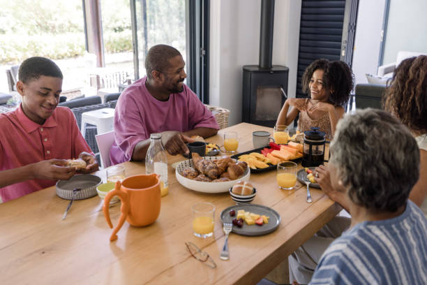 istock Children excitedly chatting while parents enjoy their morning coffee. 2198439760