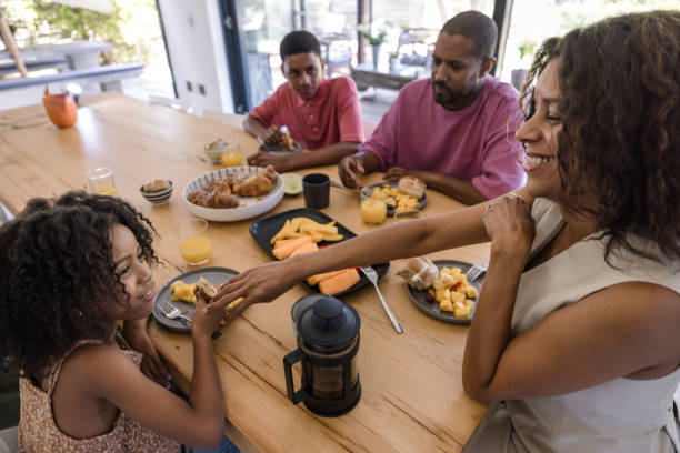 istock Smiling parents and children bonding over a nutritious breakfast. 2198439766