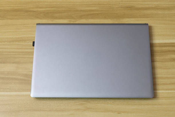 istock the objective laptop on wooden background 2198441556