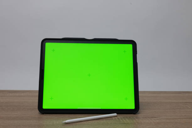 istock the Object Digital tablet with a Green screen and headphones in the working space 2198441601