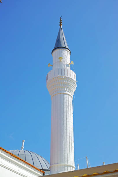 The golden dome of the mosque with a crescent moon. The minaret. Urban architecture.