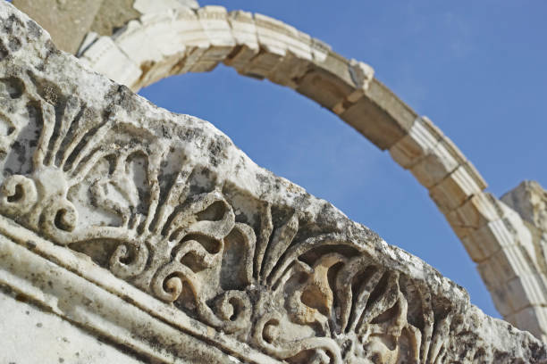 The Temple of Apollo is a Roman temple built around 150 A.D. during the Pax Romana era in the ancient Carian town of Side, in southern Turkey on the Mediterranean Sea coast and dedicated to Apollo, the Greek and Roman god of music, harmony and lightAn impressive artifact of Roman architecture, this image showcases three delicately crafted ancient columns from an archaeological site in Turkey, symbolizing history, culture, and artistic triumphs over time.