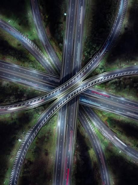 istock Highway intersection seen from above at night with light trails 2198450495