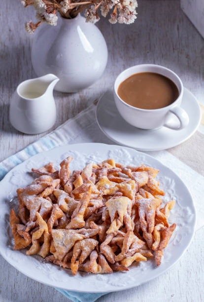 istock Traditional Maslenitsa dessert angel wings served with coffee on a light background. 2198453648